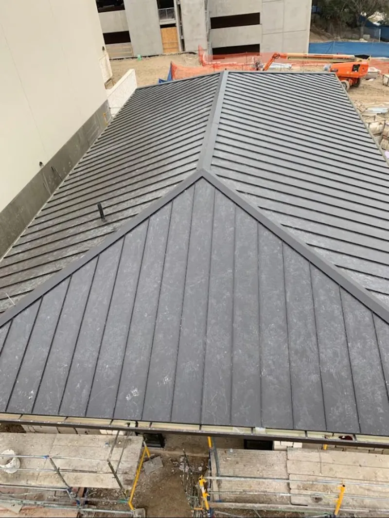 Commercial metal roof construction with crane equipment in New Hanover